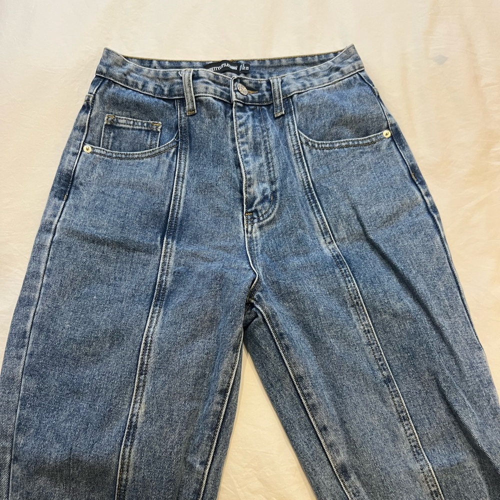 High-rise medium wash jeans with split hem near ankle